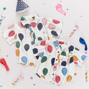 Your little one will be the life of the party in this fun-loving Balloon Bunches print. Signature details on this short sleeve, collared staple are a pattern on pattern roomy front chest pocket and a faux coconut button front closure. 